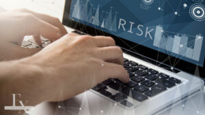 photo of man at computer with the word risk